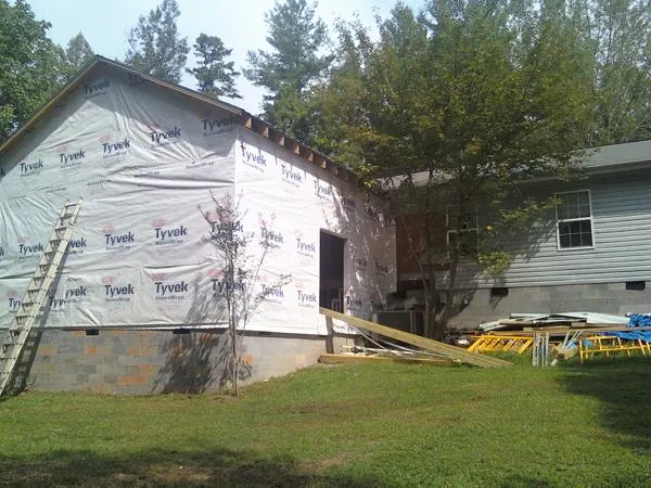 Tyvek wrapped gable on a new room addition beside an existing home in Martinsdale